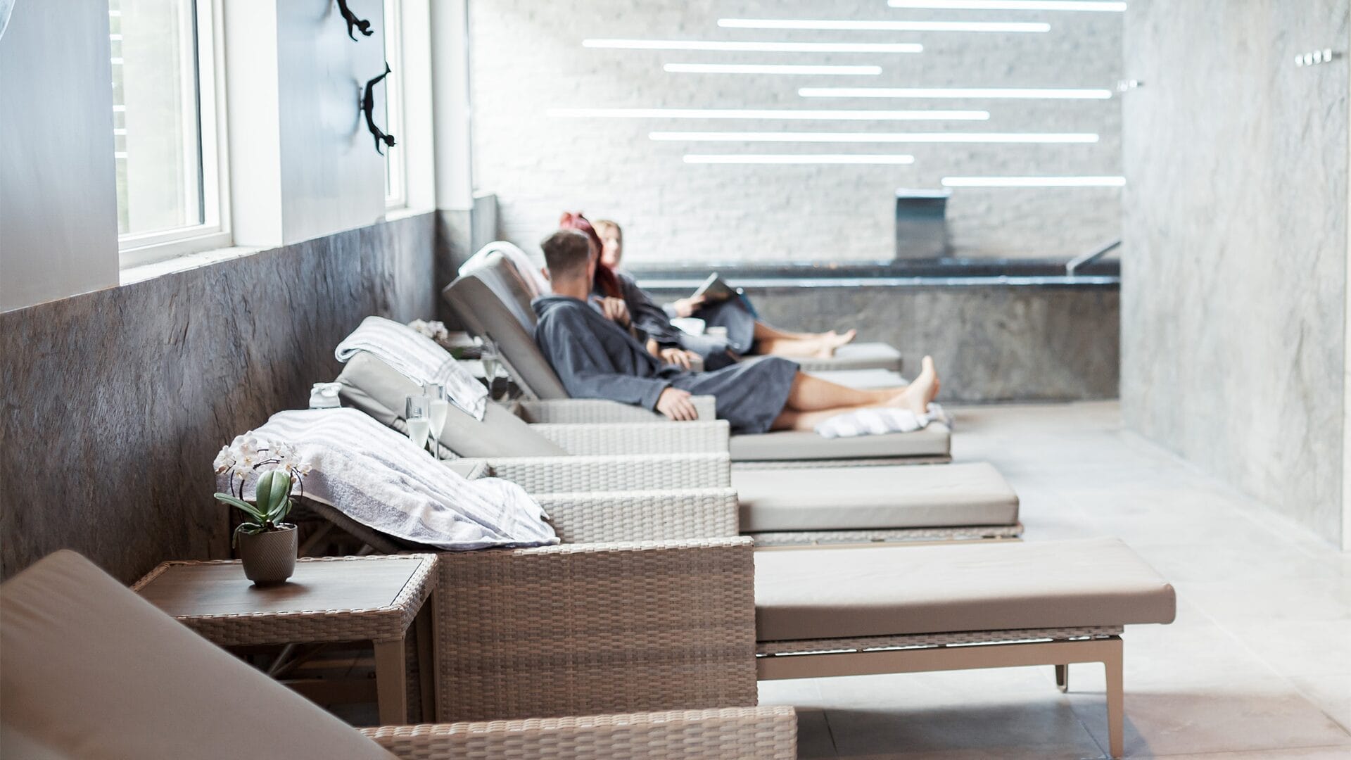 Two people sitting on a chair in a spa