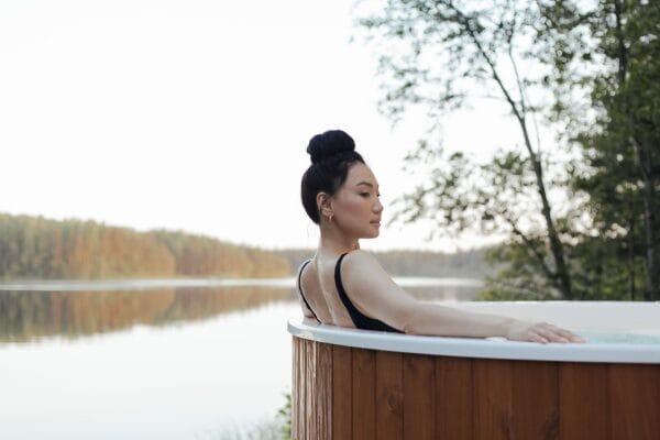 A customer enjoying her time at a luxury heated outdoor spa, despite the unpredictable weather in the UK.